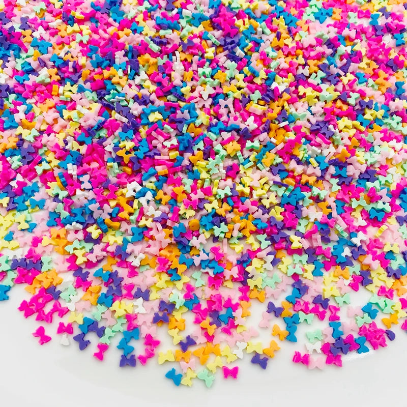 A pile of colorful polymer clay star and heart sprinkles in various bright colors like pink, blue, yellow, and purple.