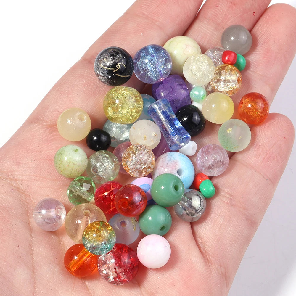 A hand holds a colorful mix of vibrant glass beads for DIY jewelry making