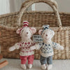 Two handmade mouse plush dolls wearing retro knitted outfits standing in front of a woven basket