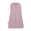 A sleeveless cotton baby sleeping bag sack in a dusty pink color with a subtle white pattern.