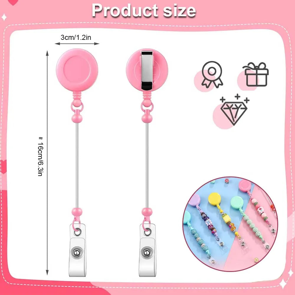 Pink beadable badge reels with retractable clips shown next to a measuring scale.