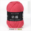 A skein of pink milk cotton yarn labeled in English and Chinese characters for knitting and crochet