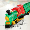 A red and green Christmas steam train toy with a black smokestack and yellow details lying on a white surface.