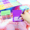 A hand is opening a purple diamond painting storage organizer box, revealing a tray of colored sequins and beads.