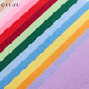 A close-up of colorful non-woven felt fabric sheets arranged in diagonal stripes.