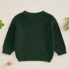 A dark green knit sweater for a baby or kid featuring letter embroidery.