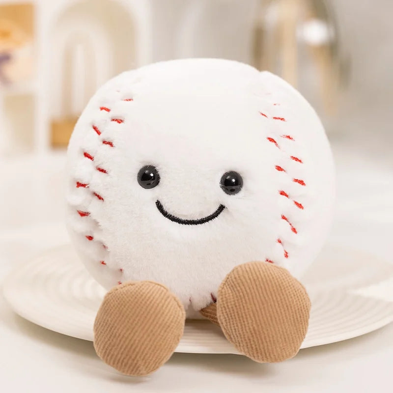 A white plush sports ball companion with stitched seams and small brown feet resting on a white plate.