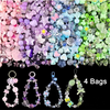 A collection of colorful acrylic beads in various shapes and sizes, including pinks, purples, blues, and greens, displayed al