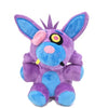 A purple and blue plush toy of a character with large ears and a spiky crown.