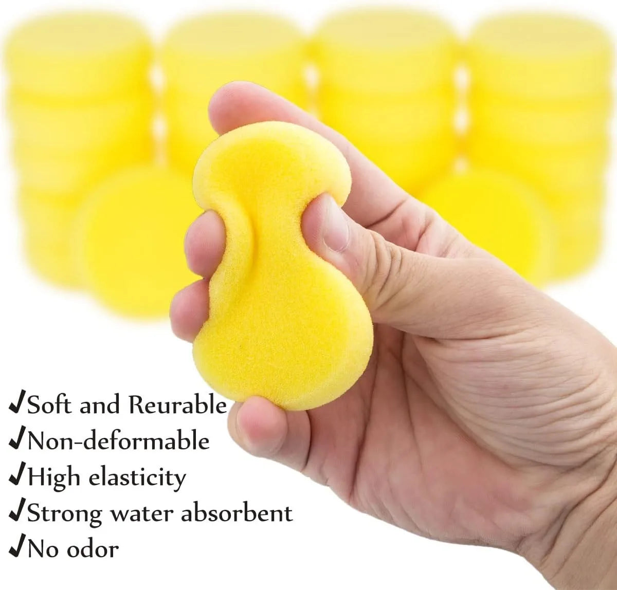 A hand holds a yellow, soft, non-deformable paint sponge against a background of stacked sponges.