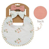 A baby flower bib and headband set featuring a pink bow and a white floral-patterned bib.