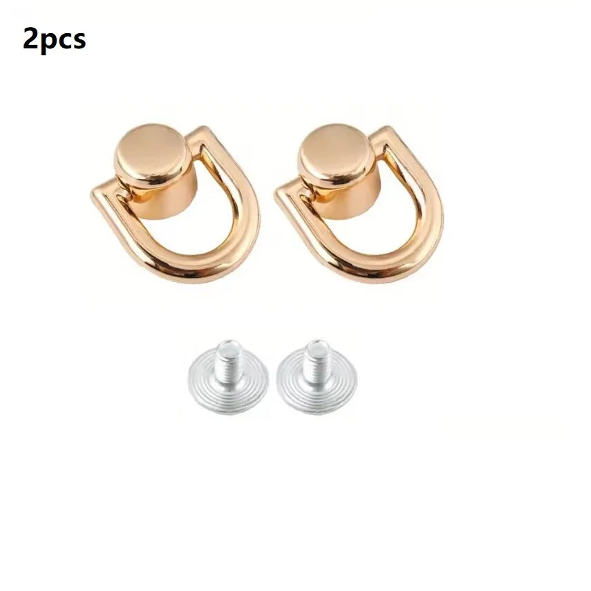 Two gold-colored D-shaped metal bag handles with screws for DIY purse straps and craft hardware