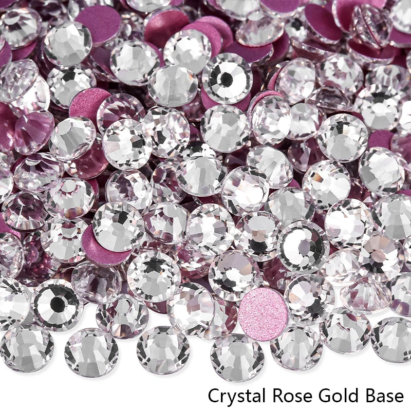 A close-up view of sparkling crystal rose gold base rhinestones in various shades of pink and silver.