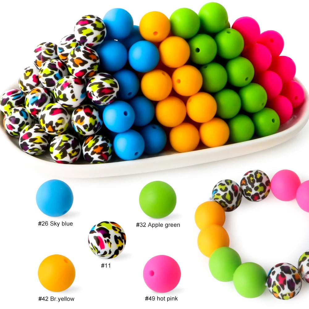 A collection of colorful silicone beads in various shades including blue, yellow, green, and pink.