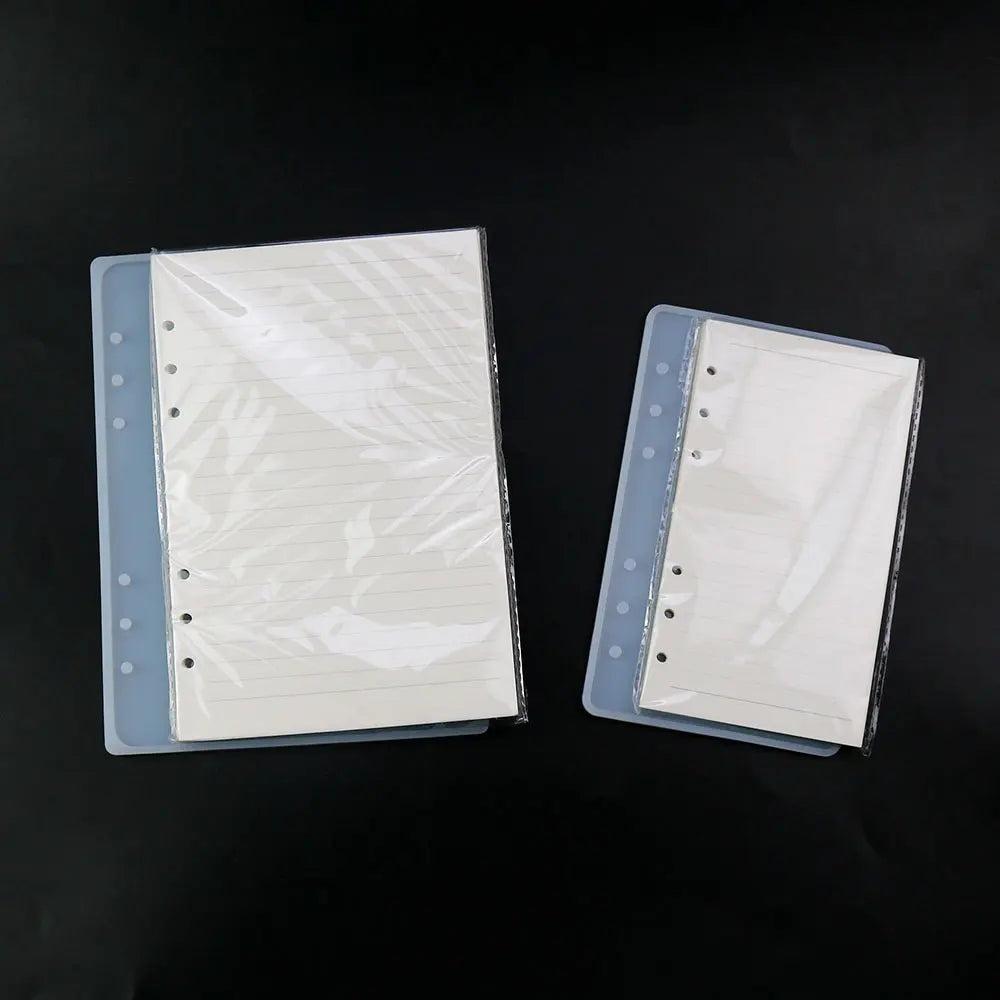 A stack of clear silicone mold covers for an epoxy resin notebook, showing different sizes.
