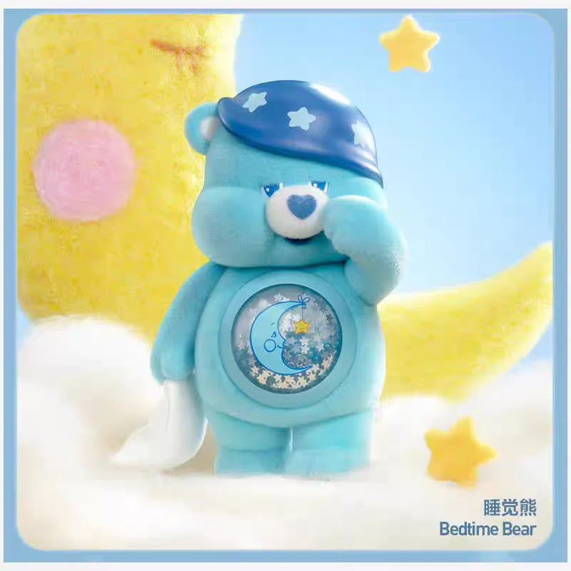 A blue Care Bear figurine with a blue cap and a crescent moon emblem, set against a yellow and light blue background.