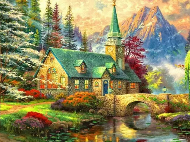 A picturesque forest house with a steeple and stone bridge over a stream, surrounded by lush greenery and mountains.