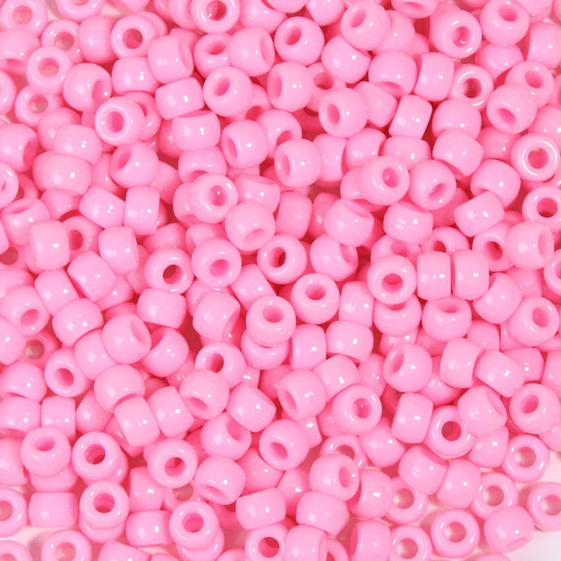 A close-up view of a large pack of pink pony beads used for jewelry making and craft projects.