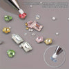 A close-up of a customized drill mud pen with various colored and clear gemstone tips for nail art application.