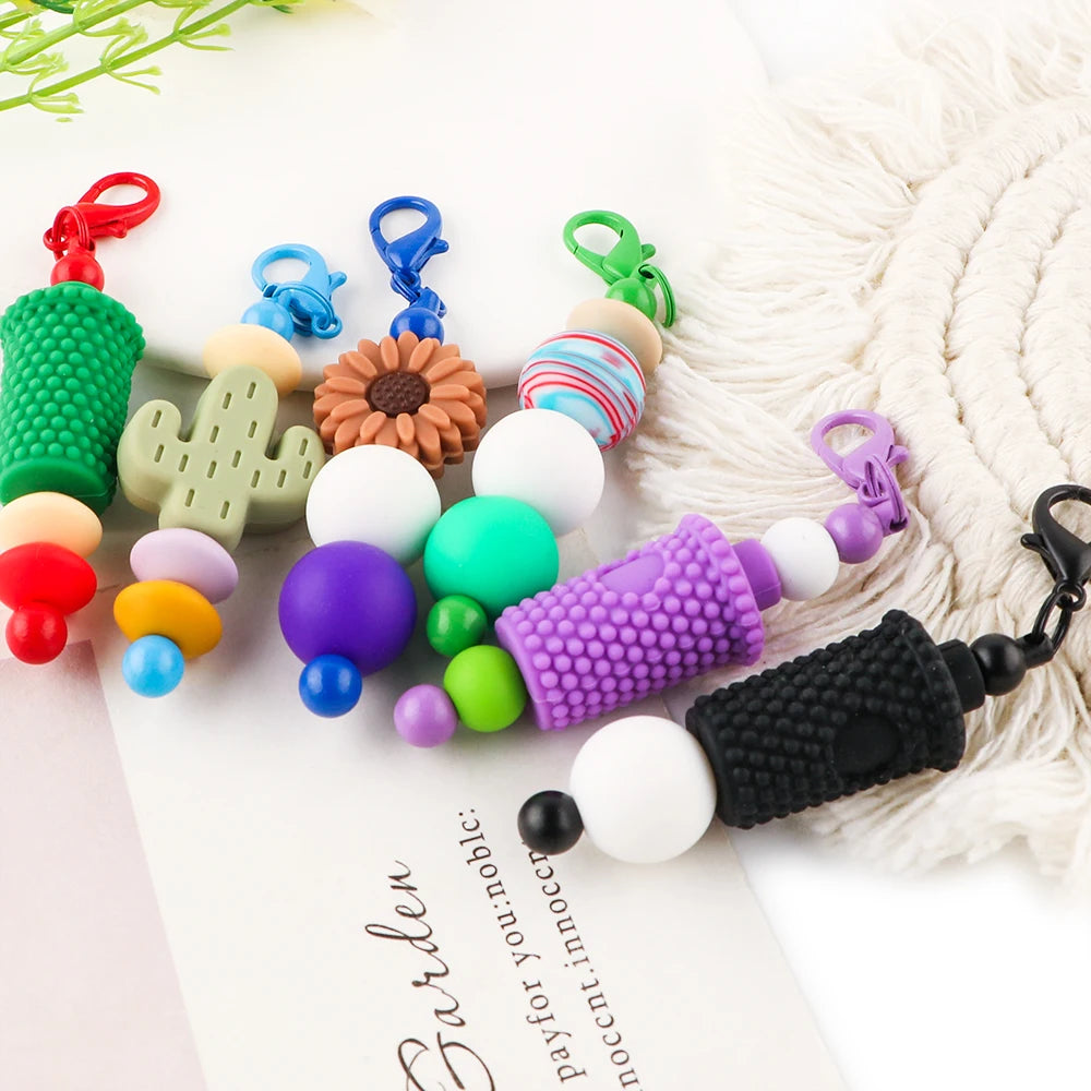 Assortment of colorful metal keychain bars with lobster clasps for DIY jewelry making displayed on a white background.