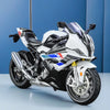 A white and black 1:12 scale die-cast model motorcycle with front steering displayed against a blue background.