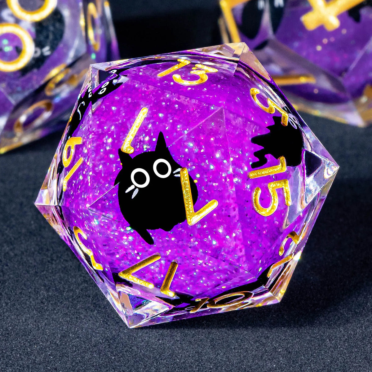 A purple liquid core resin dice set with sharp edges featuring a black cat design and gold numbers.