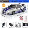A silver 1/18 scale GTR R34 RC drift car model with a black roof and blue stripes, shown next to its remote control and acces