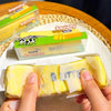 Hands hold a yellow squishy butter bar stress relief toy next to other squishy bars.
