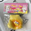 A yellow squishy toy shaped like steamed bread is sealed in a clear plastic bag with colorful packaging.