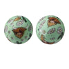 Two round silicone beads featuring a stylized brown face with horns and floral patterns.