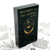 A black box containing a Messages From The Universe Oracle card deck with gold lettering and celestial designs.