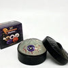 A black box of Halloween-themed squishy stress relief toys and an open black container with a translucent, glowing sphere.