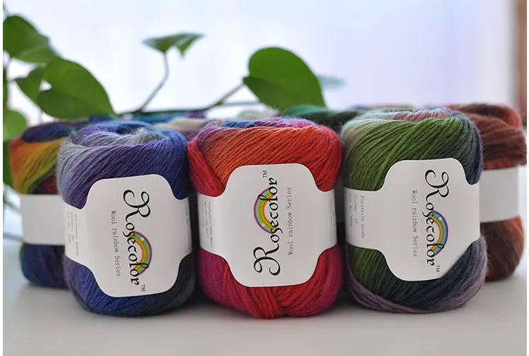 A collection of hand-dyed merino wool yarn spools in various colors, including purple, orange, pink, and green.