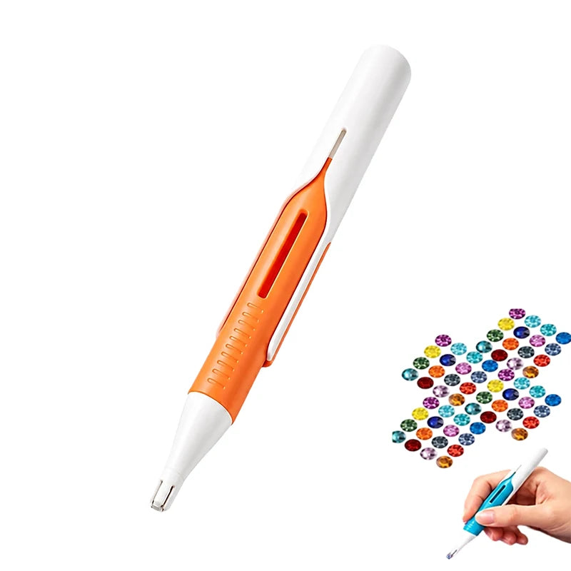 A white and orange diamond painting pen with an automatic bead dispenser is shown being held by a hand.