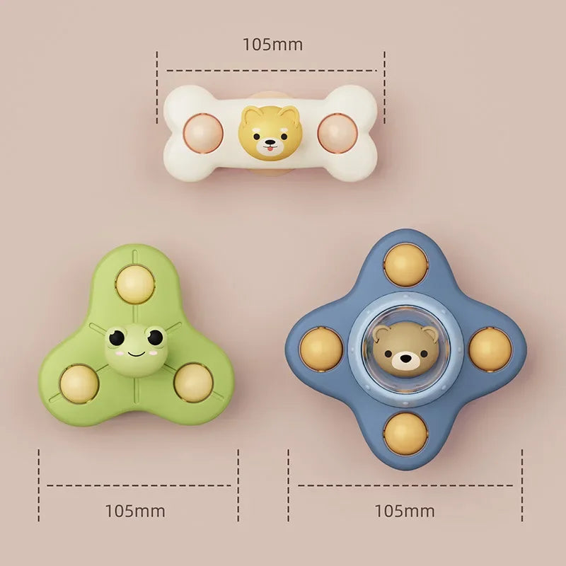 A set of three baby bath toys featuring a bear face, one green spinner, and one blue spinner.