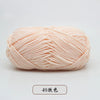 A ball of light peach colored pre-dyed milk cotton yarn for knitting and crochet.