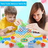 A woman and a boy are playing with a colorful Tetra Tower Balance Game made of stacking blocks.