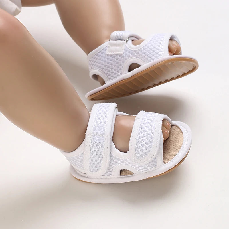 White breathable first walker sandals for baby with a soft sole and hook-and-loop closure