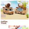 A light brown toy coffee truck resembling a vintage delivery vehicle with a cylindrical top, sitting on a yellow surface.