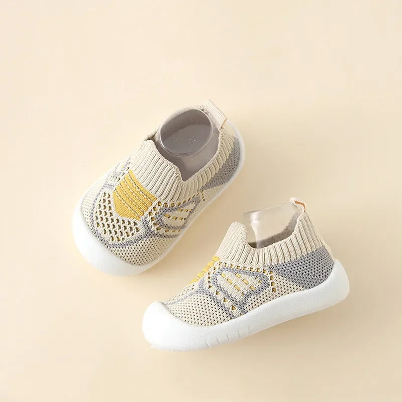 A pair of beige and gray breathable anti-slip baby first walker shoes with a woven texture.