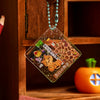 A square clear acrylic charm featuring various Japanese vintage kawaii stickers on a teal beaded necklace.