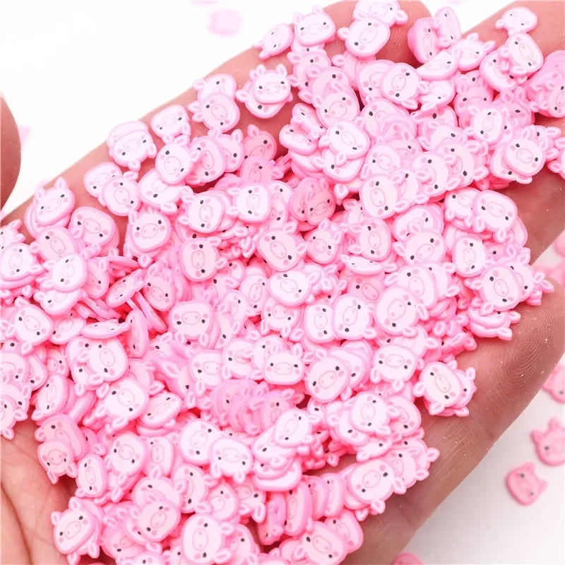 A hand holds a pile of pink polymer clay slices assorted for DIY crafts.