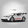 White Porsche 911 GT3 RS diecast model car shown in a side profile against a gray background.