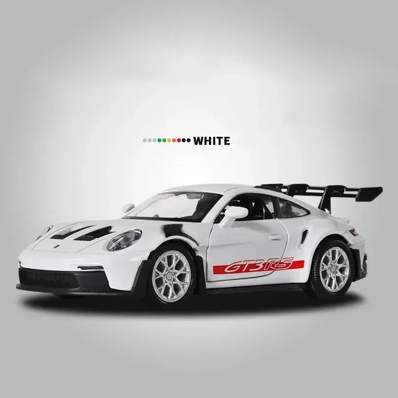 White Porsche 911 GT3 RS diecast model car shown in a side profile against a gray background.