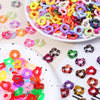 A close-up view of colorful wave-patterned acrylic beads in various shades and sizes for jewelry making.
