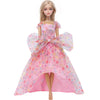A female doll wearing a pink polka dot evening gown with puffed sleeves and a full skirt.