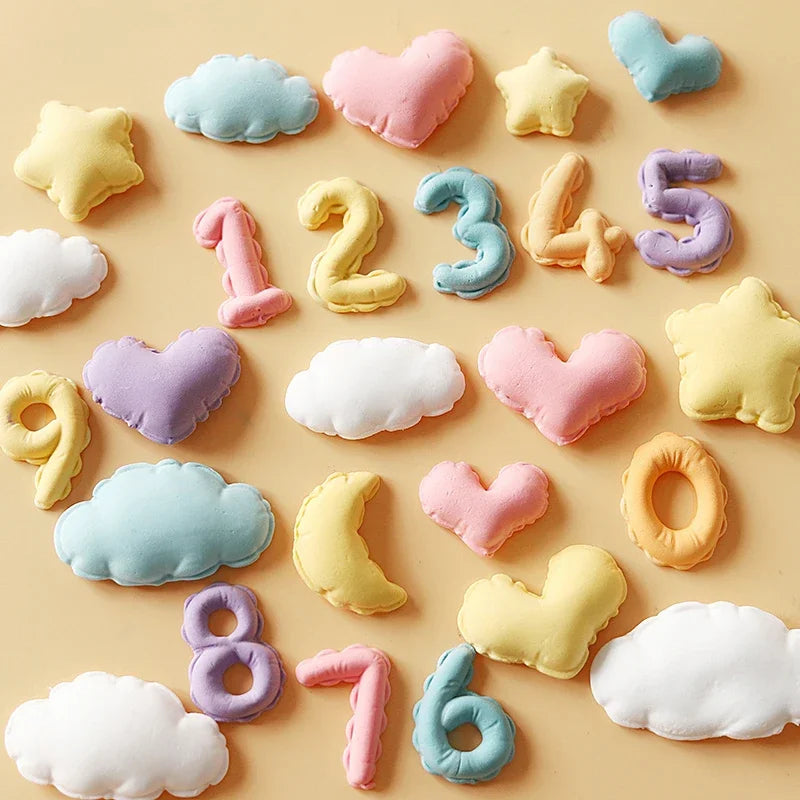 A collection of colorful silicone molds shaped like clouds, hearts, stars, and numbers for baking and crafts