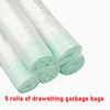 Five rolls of clear plastic drawstring garbage bags for waste disposal.