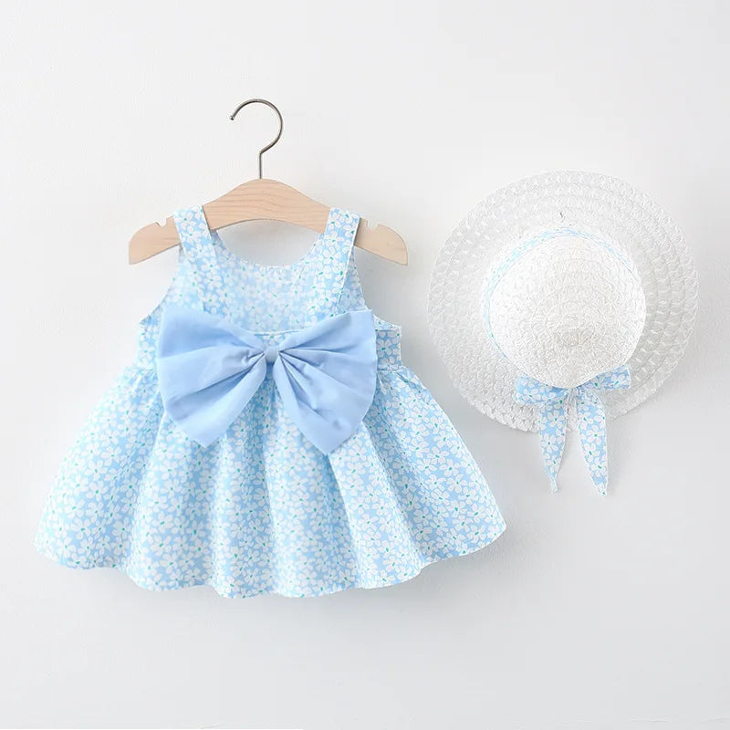 A light blue floral baby girl summer dress with a bow and a matching white sunhat