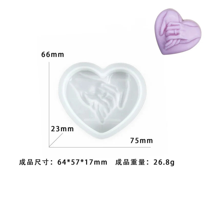 A pink heart-shaped silicone mold with a detailed hand design, shown in various views.
